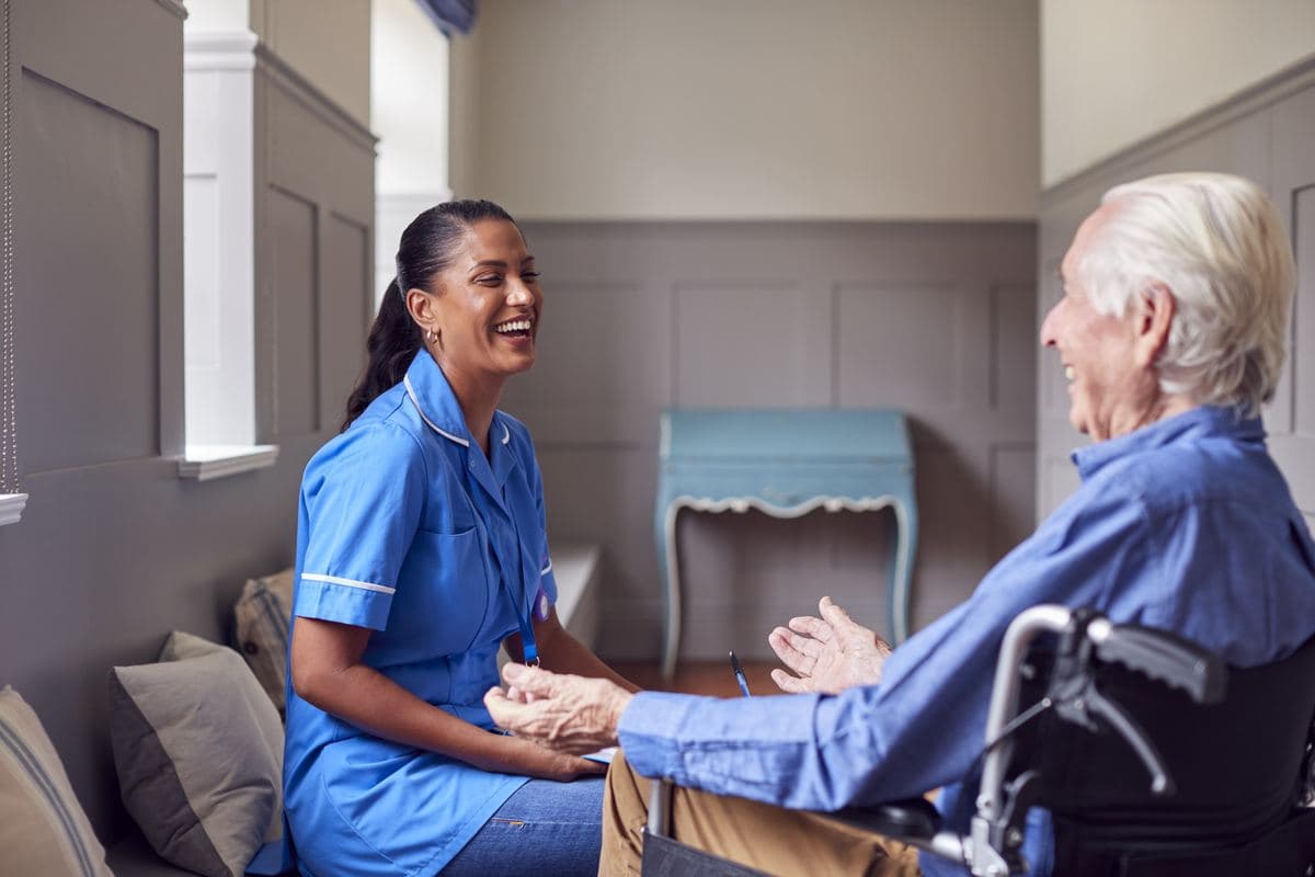 Hospice and Palliative Care ACHPN advanced practice nurse talking with a senior man in a wheelchair
