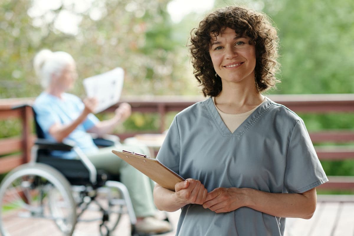 Hospice and Palliative Care clinician holding a clipboard in an assisted living facility