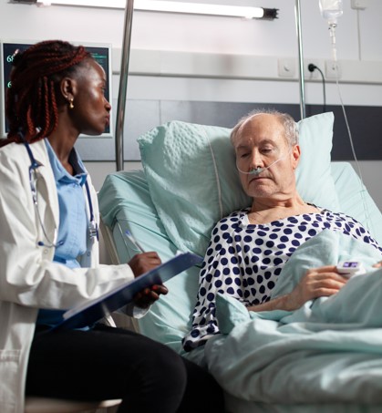 A nurse studying with a comprehensive CHPN question bank on a laptop, surrounded by study notes and a stethoscope, preparing for the Certified Hospice and Palliative Nurse exam.